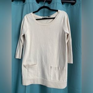 Tan sweater with front pockets and button detail